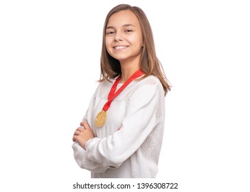 Happy Winner. Portrait Of Beautiful Teen Girl Student With Gold Medal. Smiling Child Celebrating Her Success, Isolated On White Background. Back To School Concept.