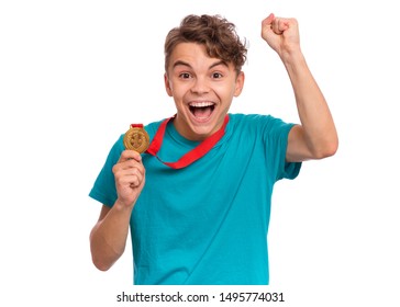 Happy Winner. Portrait Of Handsome Teen Boy Student Holding Gold Medal. Smiling Child Celebrating His Success, Isolated On White Background. Back To School Or Sport Concept.