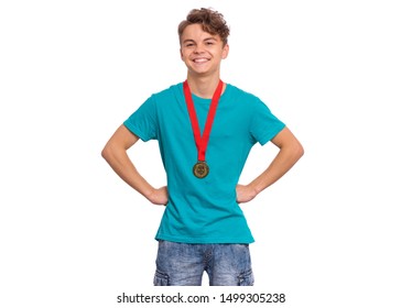 Happy Winner. Portrait Of Handsome Teen Boy Student Holding Gold Medal. Smiling Child Celebrating His Success, Isolated On White Background. Back To School Or Sport Concept.