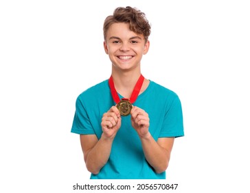 Happy Winner. Portrait Of Handsome Teen Boy Student Holding Gold Medal. Smiling Child Celebrating His Success, Isolated On White Background. Back To School Or Sport Concept