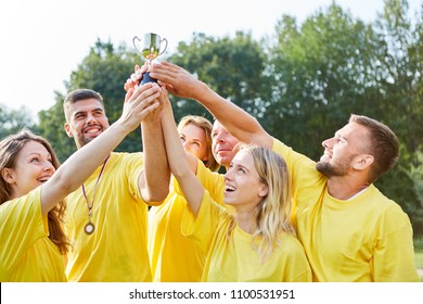 Happy Winners Team Proudly Holds The Trophy High In The Teambuilding Event