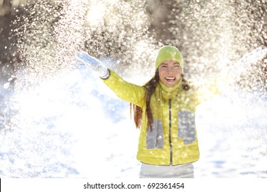Happy Winter Fun Woman Playing Throwing Snow With Arms Up Open In Freedom Enjoying The Cold Season
