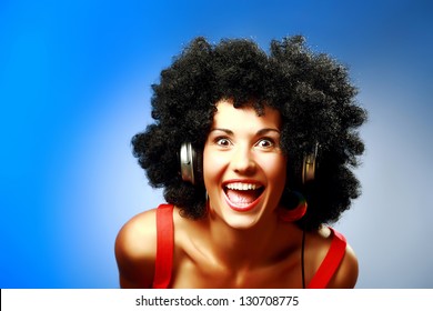 Happy woman with afro hairstyle wear headphones - Powered by Shutterstock