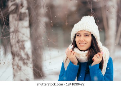 Happy Woman Applying Lip Balm Outdoors In Winter. Girl With Dry Chapped Lips Using Moisturizer Lipstick
