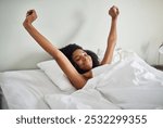 Happy woman, awake and stretching with bed in relax for good morning, sleep or rest at home. Young, female person or lying with smile for wakeup, dream or relaxation on holiday or weekend in bedroom