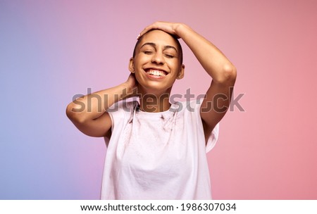 Happy woman with bald shaved hair. Female with short hair on colorful background.