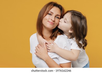 Happy Woman In Basic White T-shirt Have Fun With Cute Child Baby Girl 5-6 Years Old Hugs. Mommy Little Kid Daughter Isolated On Yellow Orange Color Background Studio. Mother's Day Love Family Concept