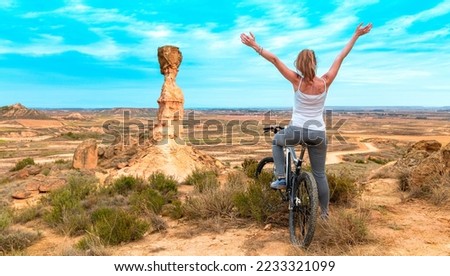 Happy woman in bike,  Monegros desert,  Huesca province