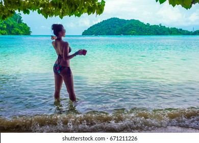 Happy Woman In Bikini Relaxing On Sea Beach Her Hand Holding Cup Of Coffee, Andaman Sea, Mu Koh Surin National Park, Phangnga, Thailand