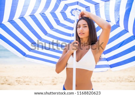 Similar – Junge Surferin mit Top und Bikini, die das Surfbrett hält.