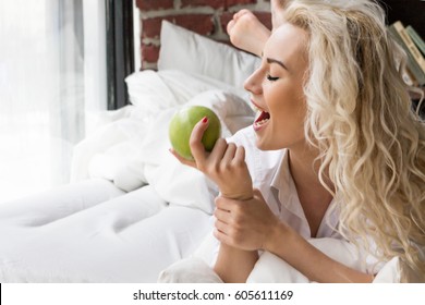 Happy Woman Biting an Apple