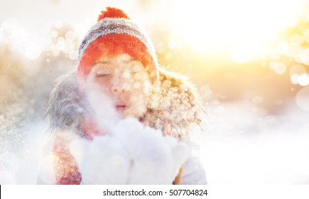 Happy Woman Is Happy And Blowing Snow In The Winter Nature