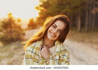 Happy woman with bread on her shoulders laughs front view and sunset in the background - Powered by Shutterstock