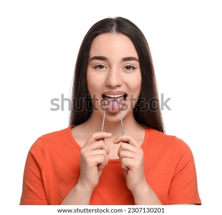 Happy woman brushing her tongue with cleaner on white background