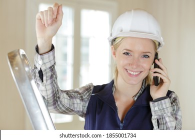 Happy Woman Builder On The Phone