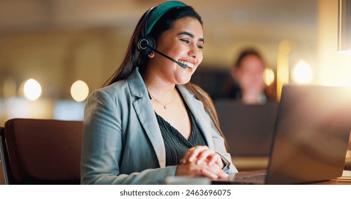 Happy woman, call center and communication with headset at night in office for customer service, lead generation. Person, CRM and laptop with faq for telecom support, contact and telemarketing advice - Powered by Shutterstock