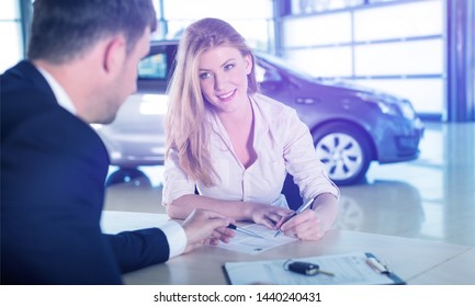 Happy Woman With Car Dealer In Auto Show Or Salon