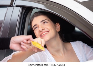 Happy Woman In Car Paying Credit Card After Refuel Car ​spending Instead Of Cash At Gas Station. Petrol Business Finance Energy Concept.