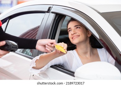 Happy Woman In Car Paying Credit Card After Refuel Car â€‹spending Instead Of Cash At Gas Station. Petrol Business Finance Energy Concept.