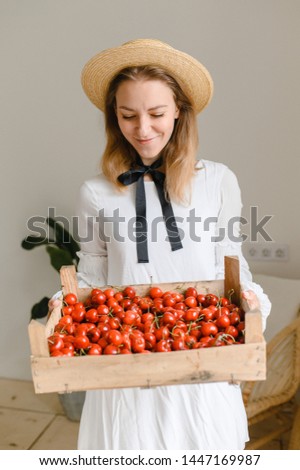 happy woman with cherries wearing hat and white dress. Healthy eating, dieting, vegetarian food and people concept