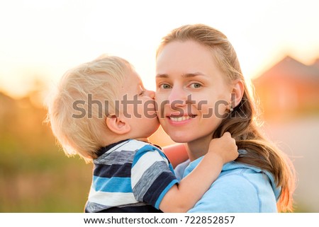 Similar – Image, Stock Photo Little boy kissing his mother on a field in summer