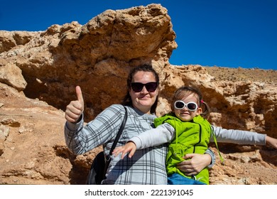 Happy Woman With A Child On The Hills Surrounded By Mountains. Mom And Kid In Charyn Canyon In Kazakhstan