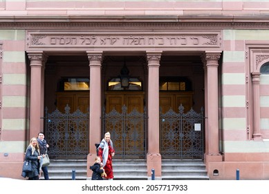 Happy Woman With Child Waving In Front Of Entrance Of Synagogue At City Of Zürich. Photo Taken October 12th, 2021, Zurich, Switzerland.