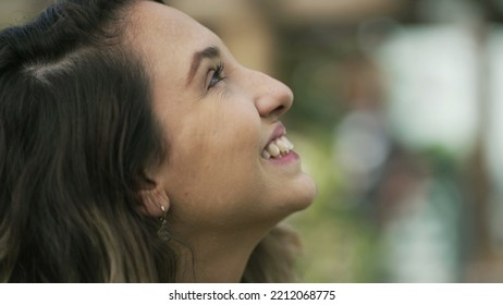 Happy Woman Closeup Face Looking Up At Sky Smiling. One Hopeful Hispanic 20s Adult Girl