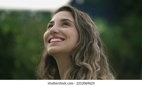 Happy Woman Closeup Face Looking Up At Sky Smiling. One Hopeful Hispanic 20s Adult Girl