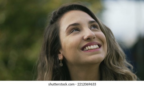 Happy Woman Closeup Face Looking Up At Sky Smiling. One Hopeful Hispanic 20s Adult Girl