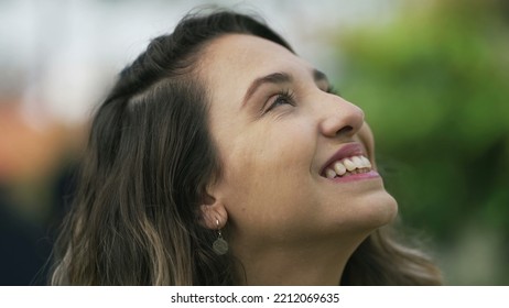 Happy Woman Closeup Face Looking Up At Sky Smiling. One Hopeful Hispanic 20s Adult Girl