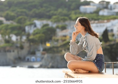 Happy woman contemplating fantastic views from terrace on the beach - Powered by Shutterstock