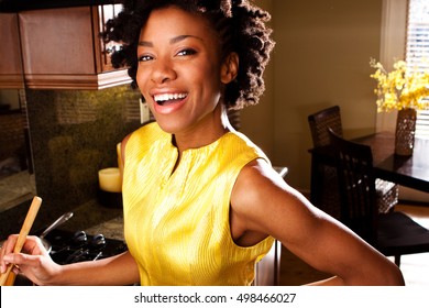 Happy Woman Cooking In A Kitchen.