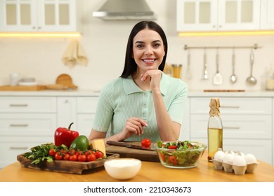 Happy Woman Cooking Salad At Table In Kitchen. Keto Diet