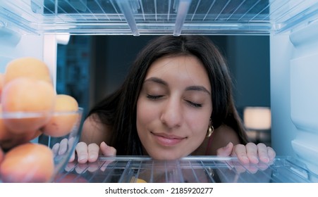 Happy Woman Cooling Herself In The Fridge During The Heatwave, POV Shot From Inside Of The Fridge