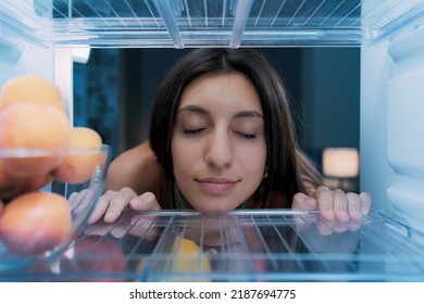 Happy Woman Cooling Herself In The Fridge During The Heatwave, POV Shot From Inside Of The Fridge