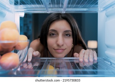 Happy Woman Cooling Herself In The Fridge During The Heatwave, POV Shot From Inside Of The Fridge