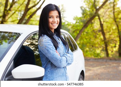 Happy Woman With Crossed Arms Standing By Her Car