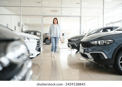 Happy woman customer female buyer client choose auto want to buy new automobile in car showroom. - Powered by Shutterstock