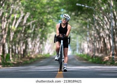 Happy Woman Cycling Athlete Prepare For Ride Bicycle On Street, Road, With High Speed For Exercise Hobby And Competition In Professional Tour