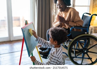 Happy Woman With Disability Learning Together With A Child. People Education Fun Concept