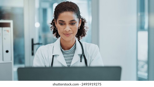 Happy woman, doctor and typing with laptop for telehealth, medical study or news at hospital. Female person or healthcare employee on computer for online medicine, research or communication at clinic - Powered by Shutterstock