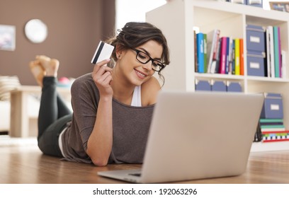 Happy woman doing online shopping at home 