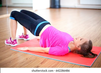 Happy Woman Doing Pelvic Muscle Exercise On Mat