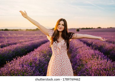 Happy woman in a dress and with open arms in lavender field. guadalajara, Spain