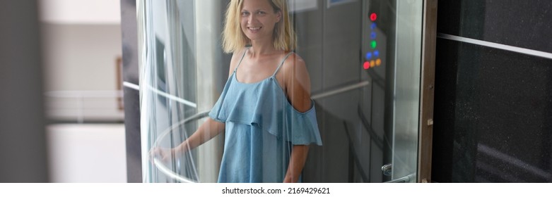 Happy Woman In Dress Rides In A Glass Elevator