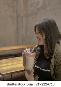 A Happy Woman Drinking Coffee In Coffeshop