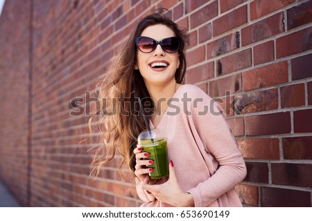 Similar – Image, Stock Photo Woman with sunglasses drinking green vegetable smoothie outdoors