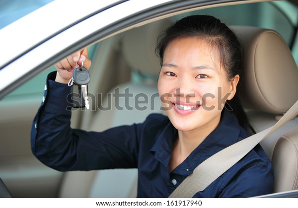 happy woman driver with\
her first car 