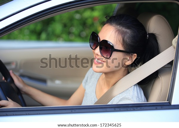 happy woman driver in her\
new car 